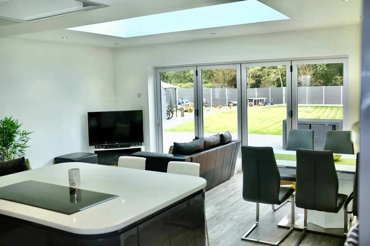 Completed kitchen, dining and living space with rooflight and garden connection