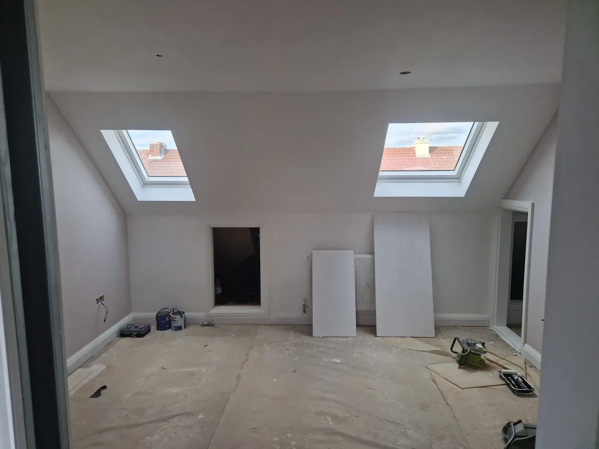 Loft bedroom during construction with roof windows installed